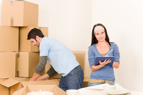 Professional movers packing boxes for a Farringdon flat move