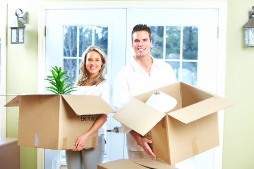 Professional movers handling boxes and furniture in Farringdon